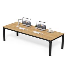 two computer monitors sitting on top of a wooden table next to each other in front of a white background