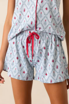 Stay comfortable and stylish all night with our All is Bright Light Blue Pajama Shorts. Made with a soft and breathable fabric, these shorts provide a cozy fit for a good night's sleep. Complete with a delightful light blue color, these shorts add a pop of festivity to your sleepwear collection. These Light Blue Pajama Shorts feature an elastic drawstring waistband with a red string, a beautiful tree and presents print and a relaxed fit. All Is Bright, Pajama Short, Christmas Pjs, Red String, Red Dress Short, Vintage Havana, Cozy Fits, Swimwear Sale, Short Pajama Set