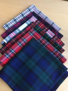 four different plaid patterns are laid out on top of each other, one is blue and the other is red