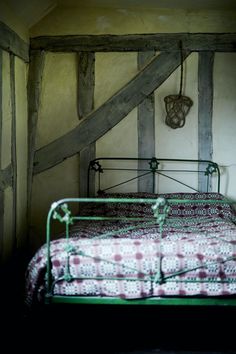 a bed in a room with wooden beams