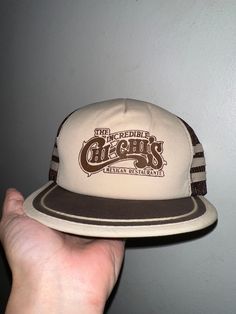 Vintage Chi Chi's Hat  - Rare  - 80's vintage  - Brown tonal  - Chi Chi's The Incredible Mexican Restaurant  - Three bar  - Trucker hat style  SnapBack OSFA  Good vintage condition No rips or holes  No stains Retro Snapback Hat With Curved Brim, Vintage Adjustable Snapback Hat With Curved Brim, Retro Snapback Cap, Retro Snapback Fitted Hat, Retro One Size Fits Most Snapback Hat, Retro Fitted Hat With Flat Bill, Retro Flat Brim Hat, One Size Fits Most, Vintage Adjustable Flat Bill Hat, Vintage Adjustable Baseball Cap With Flat Brim