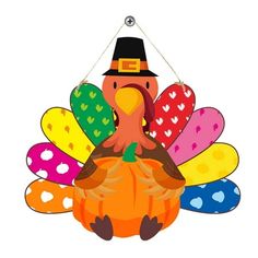 a turkey hanging from a string with hearts on it's tail and a pilgrim hat on its head