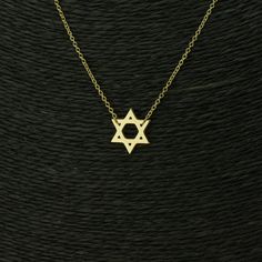 Introducing the Star of David Necklace, a beautiful and timeless piece of jewellery that represents the rich history and tradition of the Jewish people. This necklace features the iconic Star of David, which is crafted with exquisite attention to detail. The iconic Star of David, a powerful symbol of the Jewish people that represents unity, faith, and protection. Made from high-quality sterling silver - star diameter 16mm, it's a durable and long-lasting accessory that you can wear with pride So Gold Star Of David Jewelry Gift, Gold Star Of David Jewelry For Anniversary, Classic Star-shaped Necklace As Gift, Classic Star-shaped Necklace For Gift, Classic Star Shaped Necklace For Gift, Gold Sterling Silver Star Of David Necklace, Classic Star Of David Jewelry For Anniversary, Classic Star Of David Jewelry For Gift, Symbolic Star Of David Engraved Necklace