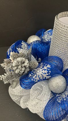 blue and silver mesh wreath next to a candle