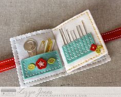 a close up of a piece of cloth with scissors and buttons on it, sitting on a table