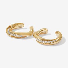 The easy way to curated ears. Aron's contrasting twisted band with crystal setting, makes it perfect to be worn alone or stacked alongside piercings. No piercing required. Pair it with a simple white tee and high waisted jeans for that effortless look. Created for you with a sterling silver base and utilizing an extra luxurious plating, these Adorn Luxe ear cuffs are everything you love, but with a ‘demi-fine’ jewelry finish. Trendy Cubic Zirconia Single Cartilage Earring, Cubic Zirconia Ear Cuff For Everyday Wear, Trendy Everyday Ear Climbers, Chic Everyday Single Ear Cuff, Curated Ears, Twisted Metal, Luxe Jewelry, Gold Ear Cuff, Silver Ear Cuff