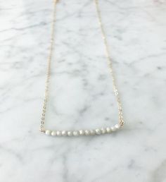 The London Bar White Silverite aNecklace / 14K Gold Fill Chain | A Blonde and Her Bag A 16" necklace of either 14K GF chain or a Sterling silver chain with 15" semi- precious stones in a row, and crystal accents at the clasp 3" Extender makes necklace 16"-19" | 1-800-Flowers Birthday Delivery The London Bar White Silverite Necklace - Gold Everyday 14k Gold Filled White Chain Necklace, Everyday White 14k Gold Filled Chain Necklace, White Gold-filled Necklaces For Everyday, Everyday 14k Gold Filled White Necklaces, Everyday 14k Gold Pearl Necklace, Everyday White 14k Gold Filled Necklaces, Minimalist Single Strand Necklace For Anniversary, Minimalist White Necklace With Satellite Chain, Minimalist White Necklaces With Satellite Chain