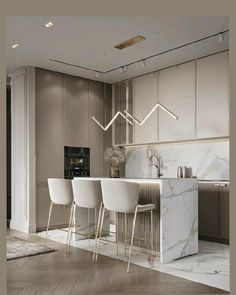 a kitchen with marble counter tops and white chairs