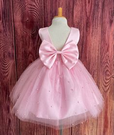 Elegant Dress With Pink Bow For Dress-up, Elegant Pink Tulle First Communion Dress, Wedding Princess Dress With Pink Bow, Elegant Pink First Communion Dress For Pageant, Elegant Pink Tutu Dress With Bow, Pink Princess Style Fitted First Communion Dress, Pink Princess Dress With Satin Bow, Pink Princess Dress With Bow For Pageant, Pink Princess Dress With Satin Bow For Dress-up