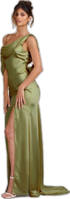 a woman in a green dress posing for the camera