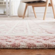 a pink rug on the floor in a living room