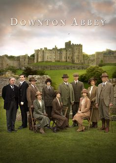 the cast of downton house posing for a photo in front of an old castle