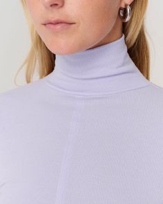 DETAILS: Color: Lavender Ribbed mock neck pullover Long sleeve Thumbholes at cuffs Design seam at front 95% Tencel, 5% Spandex Machine wash SIZE & FIT: Fits true to size Front length: 18" Bust: 13 3/4" Stretch High Neck Tops With Ribbed Cuffs, Lavender Top For Fall Layering, Lavender Top For Layering In Fall, Lavender Tops For Fall Layering, Purple Ribbed Stretch Top, Purple Stretch Ribbed Tops, Stretch Purple Ribbed Tops, Fitted Lavender Tops For Fall, Stretch Ribbed Purple Tops