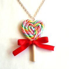 a heart shaped lollipop on a silver chain