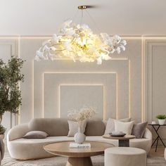 an elegant living room with white furniture and flowers on the chandelier hanging from the ceiling