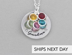 a silver necklace with three different colored stones on it and the words grandma written in cursive writing