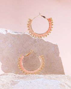 These beaded hoop earrings combine delicate premium Japanese Miyuki glass beads with gold drop accent beads for a fun and whimsical everyday hoop. Three ombre tones of beads are woven one bead at a time around a gold-filled hoop base with a lever back closure for easy on and off use. Our earrings are handmade by women artisans in Medellin, Colombia who receive fair working conditions and compensation for their skills. Materials: Miyuki Glass Beads Gold Filled Hoop Earring Base Size: Length 1.5 I Trendy Gold Beaded Earrings With Dangling Beads, Gold Hoop Earrings With Tiny Beads For Summer, Small Hoop Earrings With Faceted Beads, Gold Hoop Earrings With Faceted Beads, Summer Hoop Jewelry With Tiny Beads, Summer Dangle Hoop Earrings With Tiny Beads, Trendy Gold Hoop Earrings With Colorful Beads, Pink Gold Beaded Jewelry With Round Beads, Summer Gold Beaded Earrings