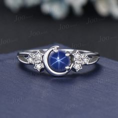 a blue ring with stars on it and a moon in the middle, sitting on top of a book