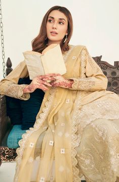 Embroidered Pakistani Salwar Kameez Dupatta Golden Salwar Suit is all set to make you look elegant in its sleek and chic printed base capri kameez paired with a chiffon dupatta in heavily embroidered style. Gold Kameez: Glistening mirrorwork and tilla embellishments on a fine Organza shirt, This is the epitome of modern couture. Reflecting timeless elegance and grandeur, the outfit comes paired with embellished raw silk trousers and a contrasting gunmetal Pink organza dupatta for the perfect pop Golden Salwar Suit, Vogue Clothing, Organza Shirt, Clothing Studio, Pakistani Salwar, Organza Sleeves, Pakistani Salwar Kameez, Chiffon Collection, Embroidered Organza