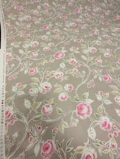 the fabric has pink flowers on it and is very light brown with white trims