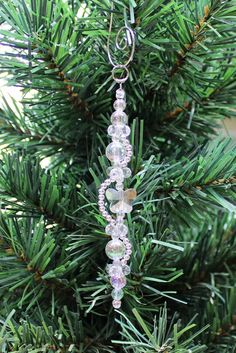 a glass beaded ornament hanging from a christmas tree