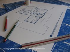 blueprints and ruler on top of construction drawings