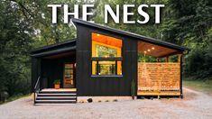 a small black cabin with the words the nest above it