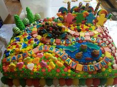 a birthday cake is decorated with candy and candies