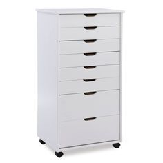 a white dresser with five drawers on wheels