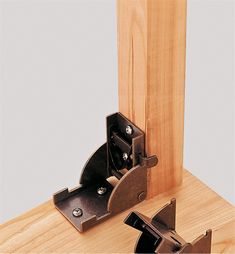 a pair of wooden brackets are attached to the side of a piece of wood