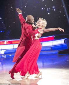 a man and woman dancing on the dance floor