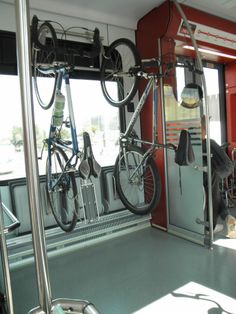 bicycles are hanging on the rack in this train car