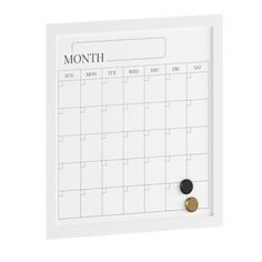 a white and gold magnetic calendar with two magnets on the front, one is for each month