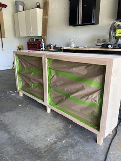 an unfinished counter with green tape on it in a room that is being worked on