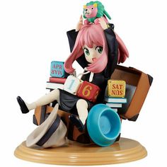 a figurine sitting on top of a pile of books and holding a cat