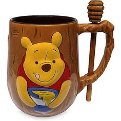 a winnie the pooh mug with a wooden handle