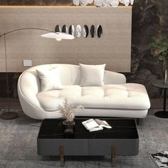 a modern living room with white couches and black tables