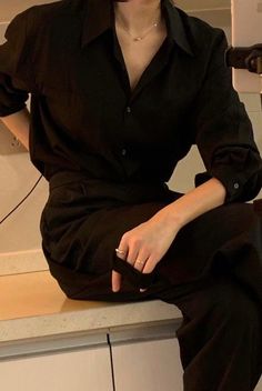 a woman sitting on top of a kitchen counter