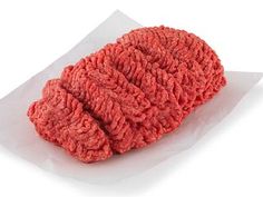 a red mop sitting on top of a piece of white paper with the end of it