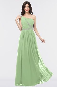 a woman in a long green dress with one shoulder and beading on the waist