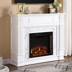 a white fireplace with a tv above it