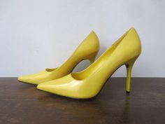 Absolutely killer Frederick's of Hollywood glossy, bright canary yellow sky high stiletto heels in really nice vintage condition! There's actually very little signs of wear inside and out, but as pictured, there's a small scratch on the outside of the right heel. Otherwise no major flaws to note.Gold Frederick's of Hollywood stamp on the insoles, black print inside reads: 8M, 64249, All Man Made Materials, Made in ChinaLabeled as a size 8M, these seem to run pretty true to size. I'm typically a Vintage Yellow Pointed Toe Heels, Retro Yellow Heels For Party, Retro Yellow High Heels, Yellow Retro Heels For Party, Yellow Retro High Heels, Neon Yellow Fitted High Heels, Fitted Neon Yellow High Heels, Yellow Pointed Toe Heels, Heels 4 Inch