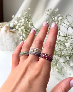 "Discover the beauty and versatility of our elastic gemstone rings, now available on ROMANIV Jewelry! My collection features a stunning array of natural gemstones including Super Seven, Emerald, Moonstone, Aquamarine, Italian Coral, Iolite, Burma Jade, Garnet, Zircon, Ruby, and Spinel. Each ring is carefully crafted with high-quality materials and designed to provide comfort and style for everyday wear. Elastic design ensures a perfect fit for any finger size making them an ideal gift for yourse Spiritual Birthstone Rings, Spiritual Birthstone Rings For Everyday, Everyday Spiritual Birthstone Rings, Adjustable Stackable Crystal Ring Fine Jewelry, Adjustable Moonstone Ring For Everyday, Adjustable Everyday Moonstone Ring, Adjustable Stackable Moonstone Ring For Everyday, Dainty Inelastic Stackable Jewelry, Dainty Stackable Jewelry