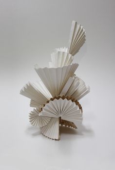 a white sculpture made out of folded paper