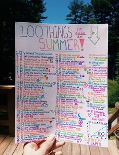 someone holding up a poster with the words 100 things to do in summer