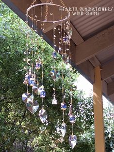 a chandelier hanging from the side of a wooden structure with trees in the background