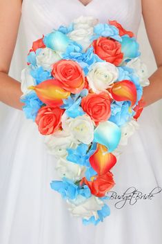 a bride holding a bouquet of red, white and blue flowers on her wedding day