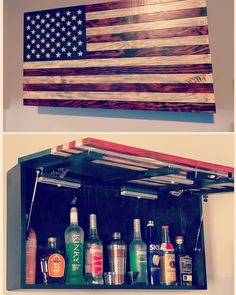 an american flag hanging on the wall next to liquor bottles in a wooden box with metal handles