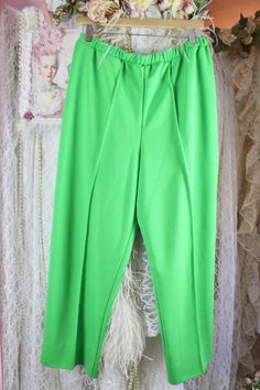 "*Vintage 70s Vibrant Green Pleated Trousers by Vera Neuman* Pre Loved Good Vintage Condition No Stains, Snags or Fade Vintage 70s Brand: Vera Material: 100% Polyester Green Pleated Trousers Pull-On Style High Waist Pleated Front Elastic Waist Bottom Single Stitch Cuffs Size Approx. X-Large Check the measurements for a better fit. Elastic Waist Waist: 32\" 37\" Around Stretched Inseam: 26 1/2\" Rise: 14\" High Hip: 42\" Around Low Hip: 44\" Around Thighs: 27\" Around Bottom Cuffs: 18\" Around Sh Vintage Full Length Bottoms For Spring, Retro Solid Color Bottoms For Spring, Retro Spring Bottoms, Vintage Spring Workwear Bottoms, Vintage Stretch Pants With Pockets, Vintage High-waisted Pants For Spring, Vintage Fitted Bottoms With Elastic Waistband, Vintage High Waist Stretch Pants, Vintage Wide Leg Pants With Elastic Waistband