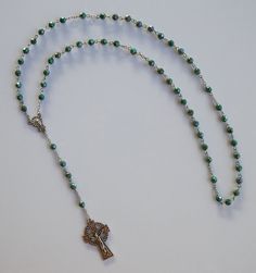 "Acrylic green faceted beads with detailed Saint Patrick Crucifix 1-1/2\" long. SIZE/LENGTH: Total length is 20\" (28\" circumference) including the Crucifix. BEADS: Quality 6 mm (1/4\") acrylic green faceted beads carefully assembled on chain. MEDAL: Zinc Alloy Center piece of The Madonna measures 5/8\" x 3/8\" CRUCIFIX: The zinc alloy Saint Patrick Crucifix measures 1-1/2\" L x 1\" W. Because of its length is can be used as a necklace rosary. This rosary includes a FREE beautiful velveteen pou Sign Of The Cross, Prayer Beads, Cord Necklace, Great Memories, Star Necklace, Faceted Bead, Rosary, Zinc Alloy, Madonna